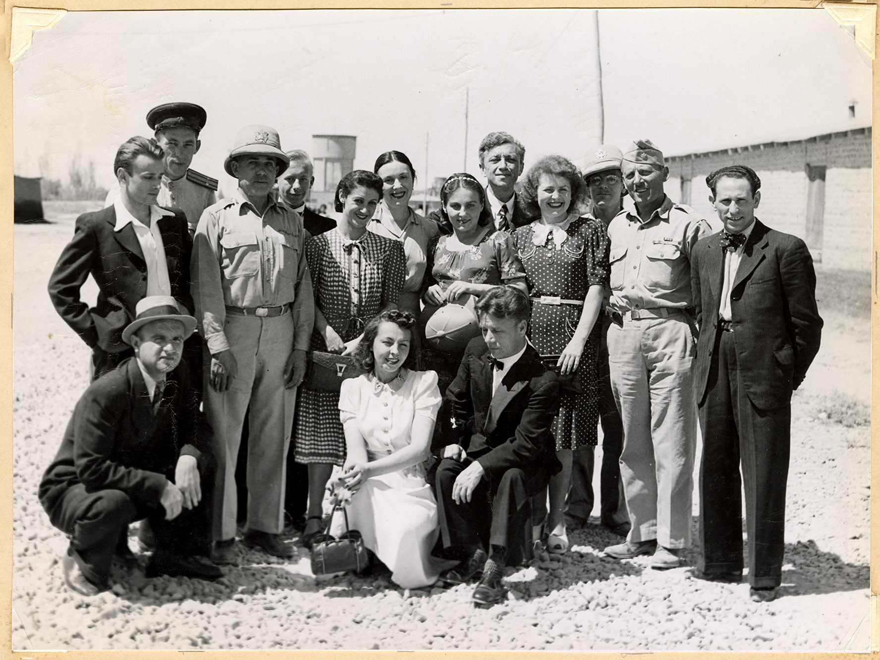 A group of several people pose outside for the camera